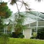 The pool area is surrounded by beautifully tended foliage.
