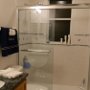 The second bedroom's ensuite bathroom features a bath with shower, toilet and direct access to the pool deck.