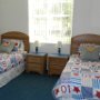 Bedroom three complete with 2 single beds and television.